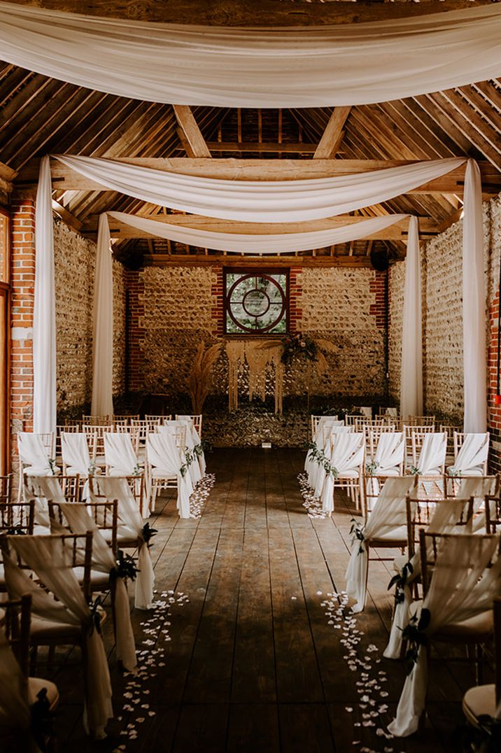 Cissbury Barns wedding venue with white drapery and neutral decorations 