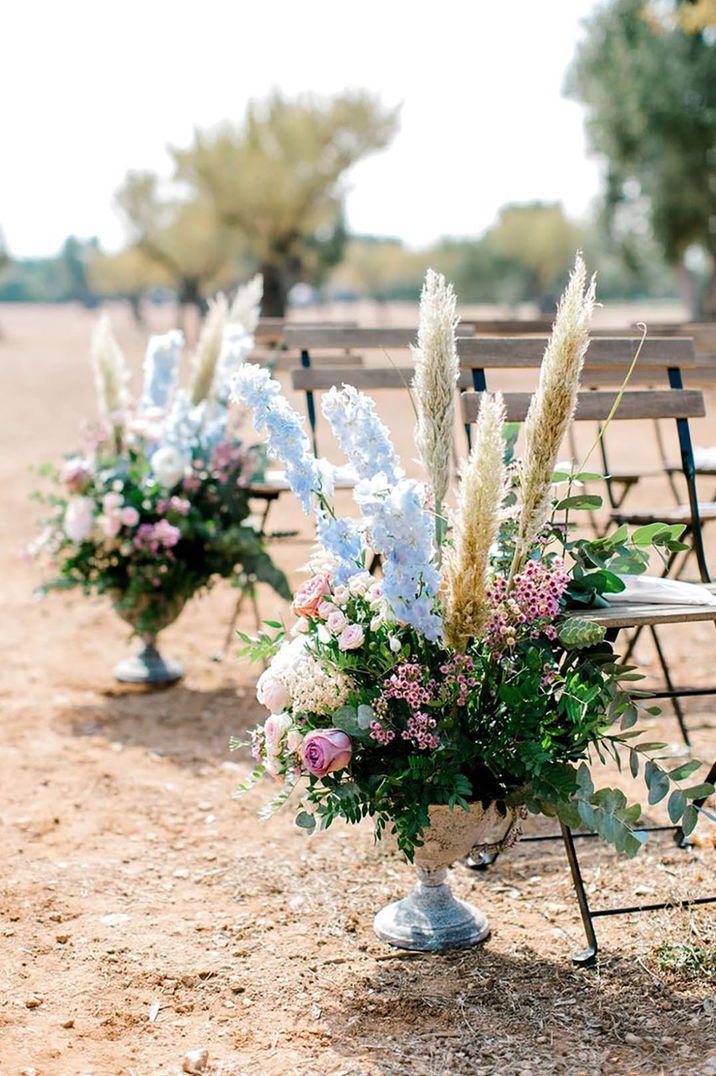 Dried pampas grass with light blue flowers and foliage as aisle flowers for destination wedding in Italy  