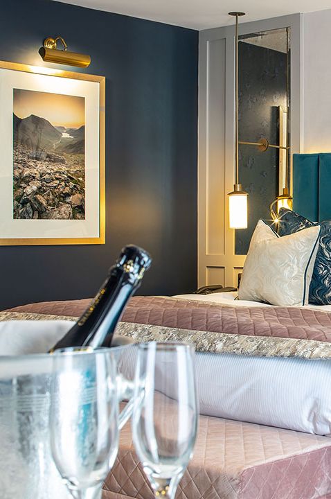 Colourful teal blue bedroom at hotel and spa with champagne 