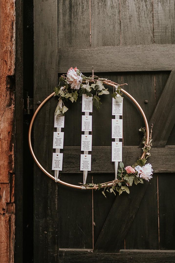 DIY hoop wedding table plan with pink flower and foliage decor 