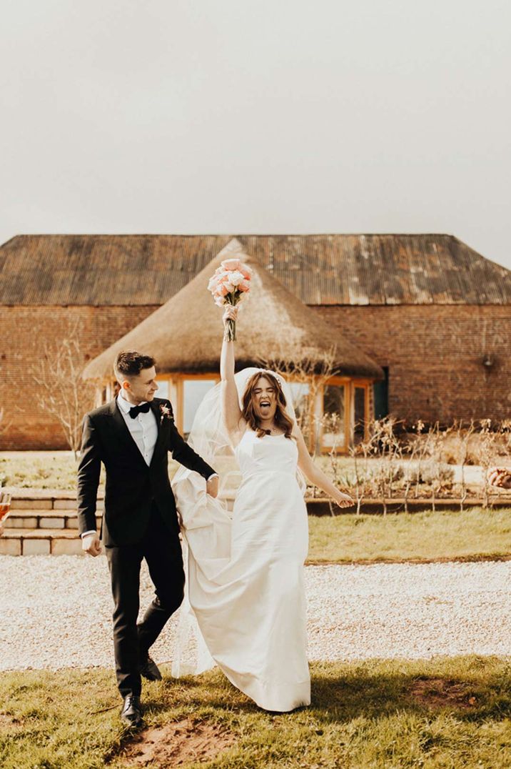 Bride and groom posing outside Brickhouse Vineyard, unusual wedding venues