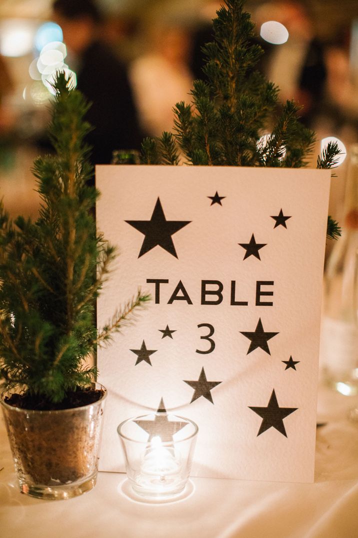 Starry table number sign with a mini Christmas tree decoration 