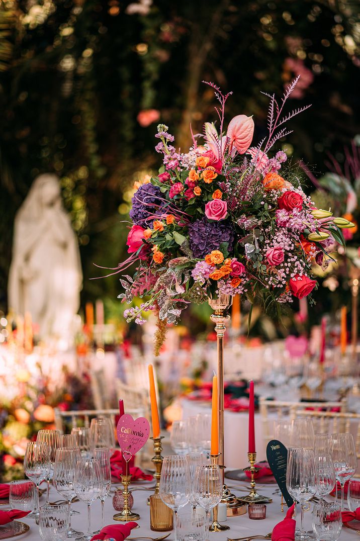 Colourful tall wedding table centrepiece with roses, hydrangeas, anthuriums and more 