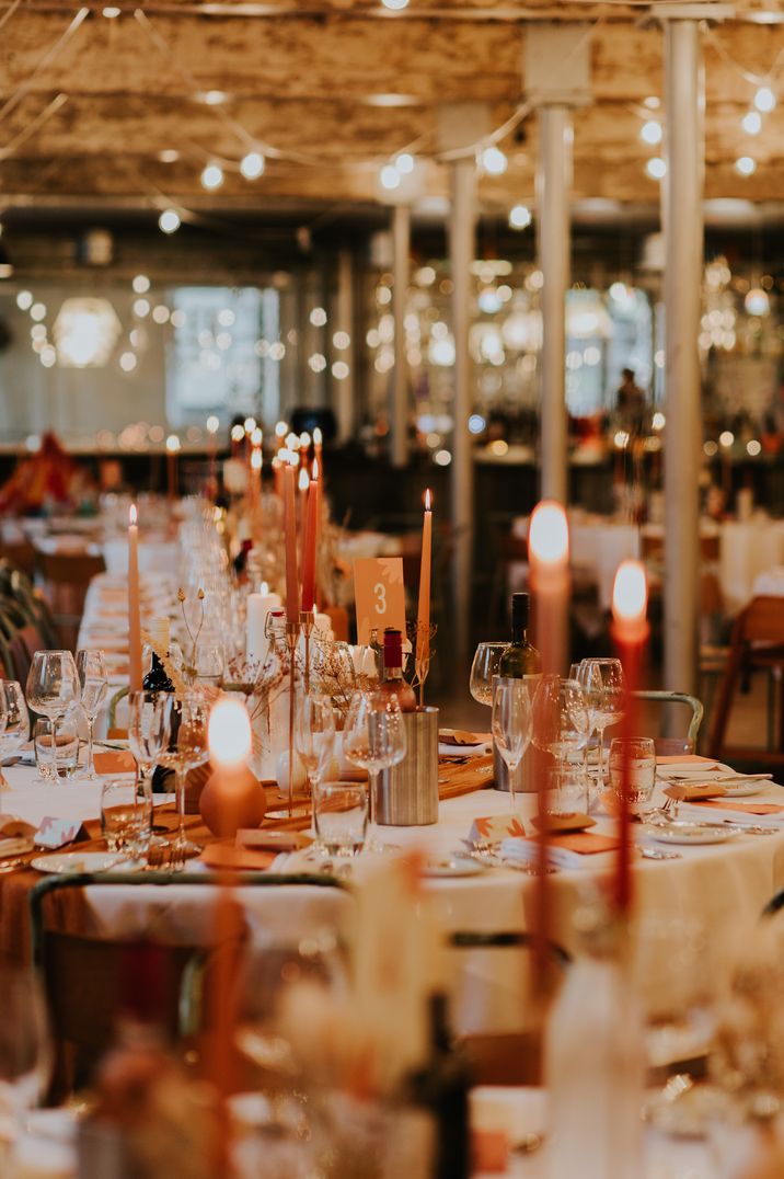 Red, orange and neutral tablescape at Holmes Mill wedding, unusual wedding venue