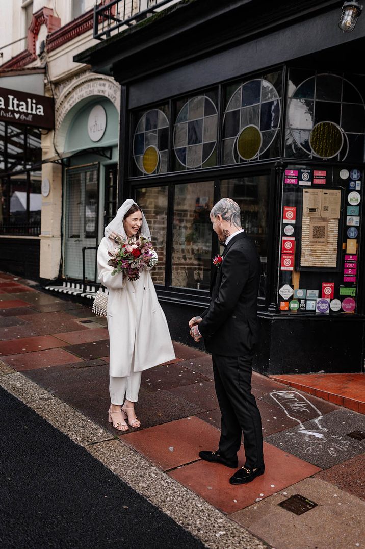 Micro wedding in Brighton with bride and groom having first look photo together 