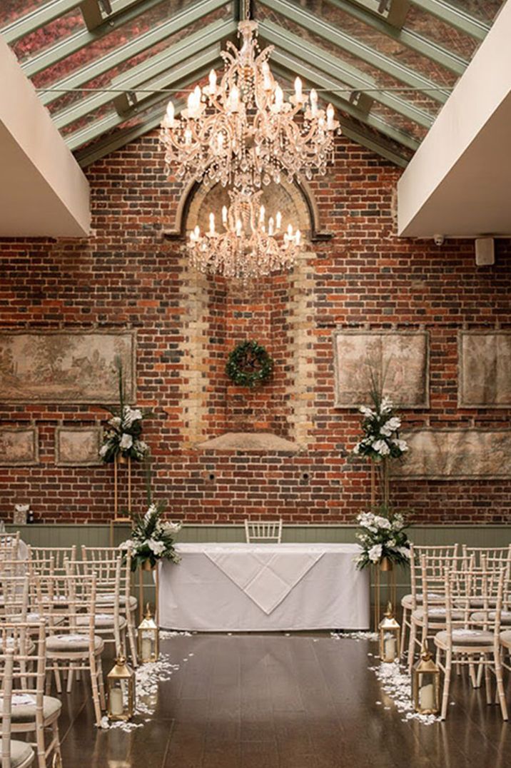 White floral wedding aisle and altar decorations with chandeliers 