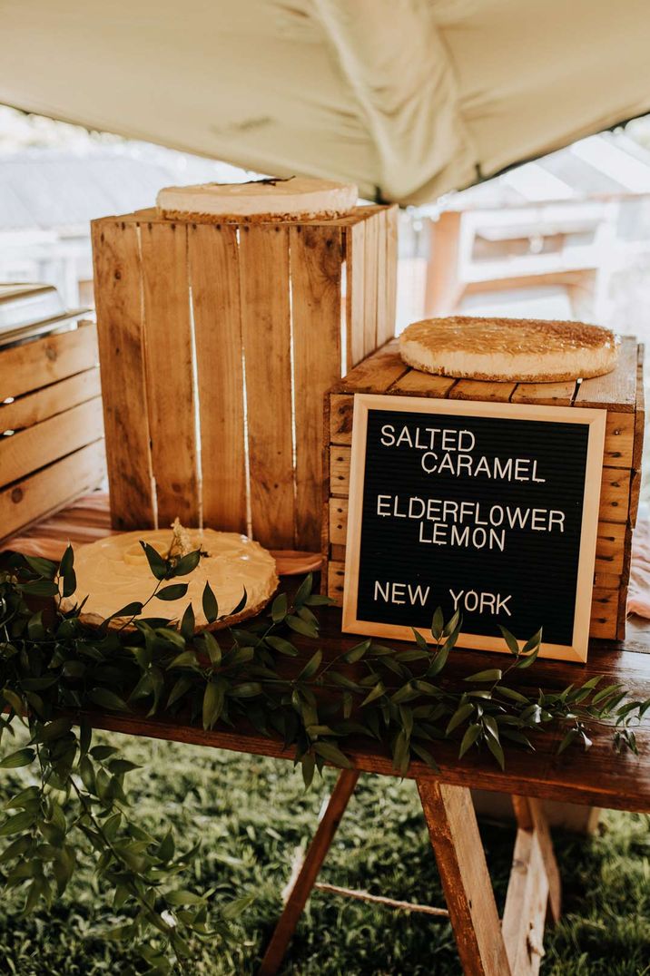 DIY chalkboard sign for different wedding cakes at garden wedding reception