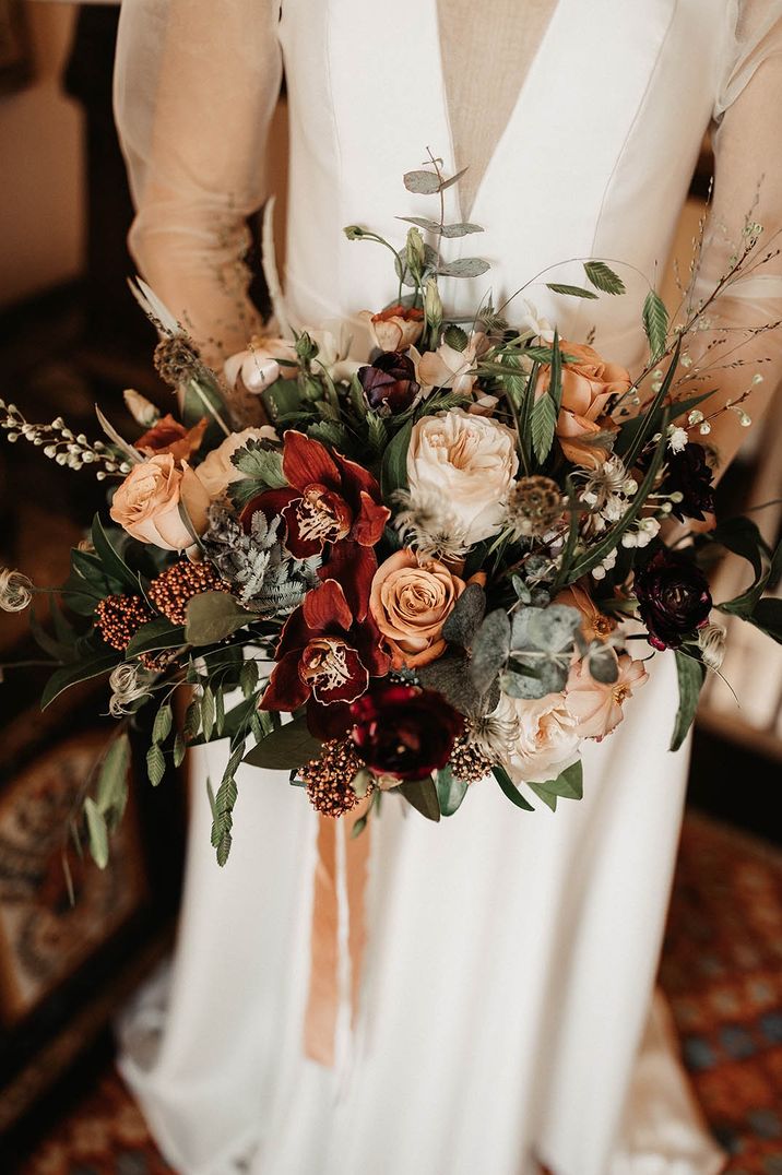 Neutral and red theme wedding bouquet by Moody Blooms with foliage 