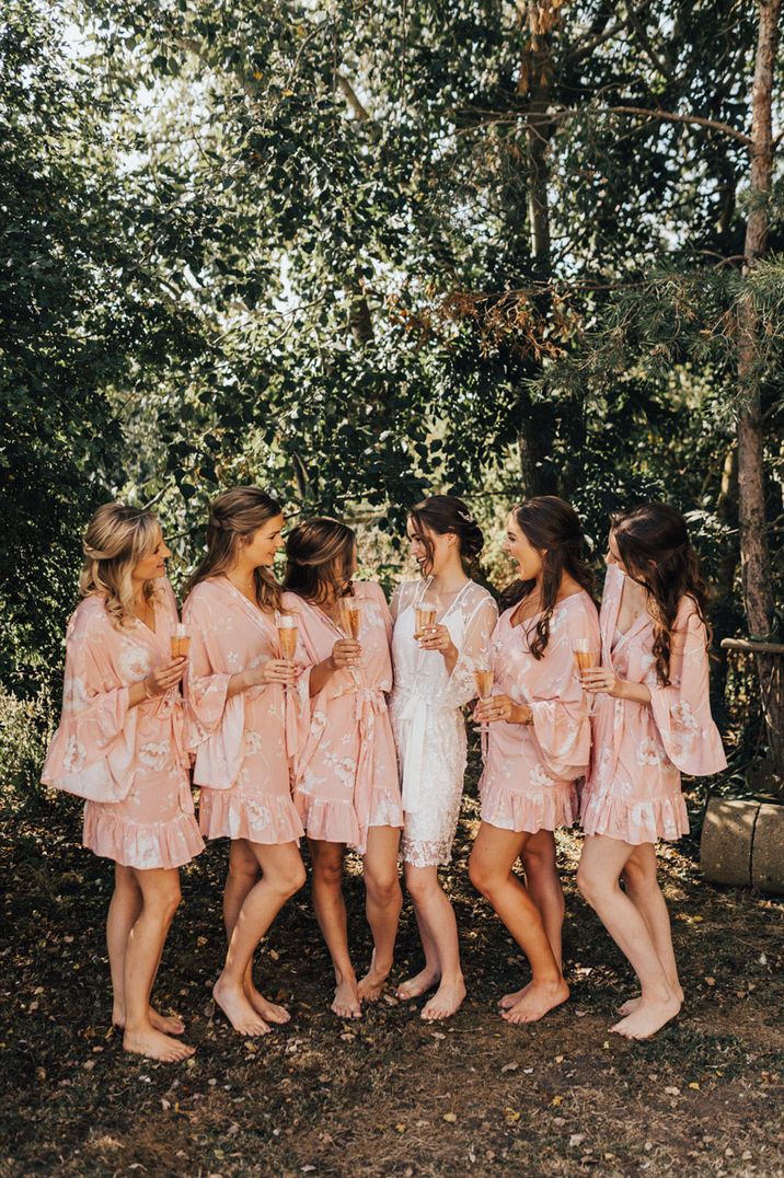 Floral patterned pink robes with bride in mesh white robe 