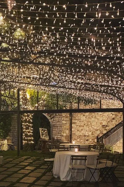 Castello di Rossino wedding venue in Italy - reception area with fairy light ceiling 