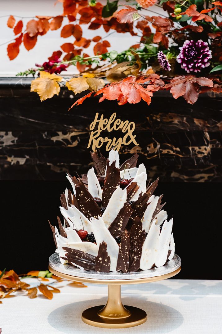 White and dark chocolate shard wedding cake with gold cake topper 