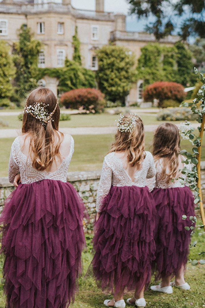 Flower girls in purple tulle dresses with gypsophila in their hair 