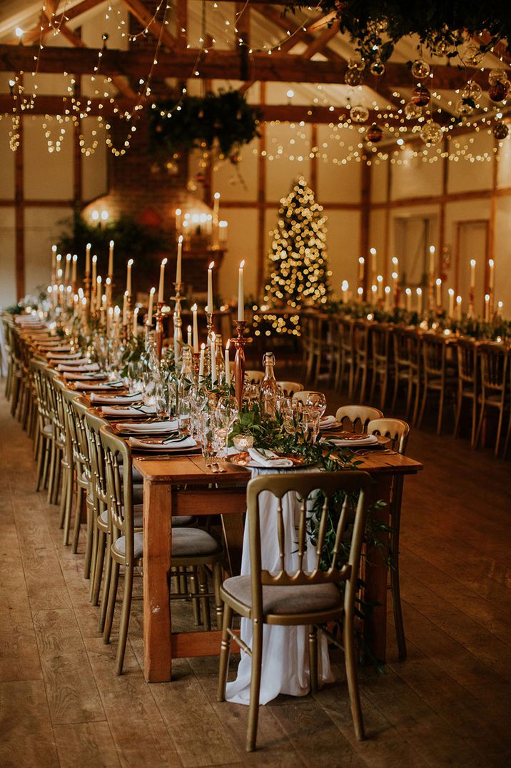 Cosy winter wedding lighting with candles, fairy lights, and a Christmas tree for winter wedding decor 