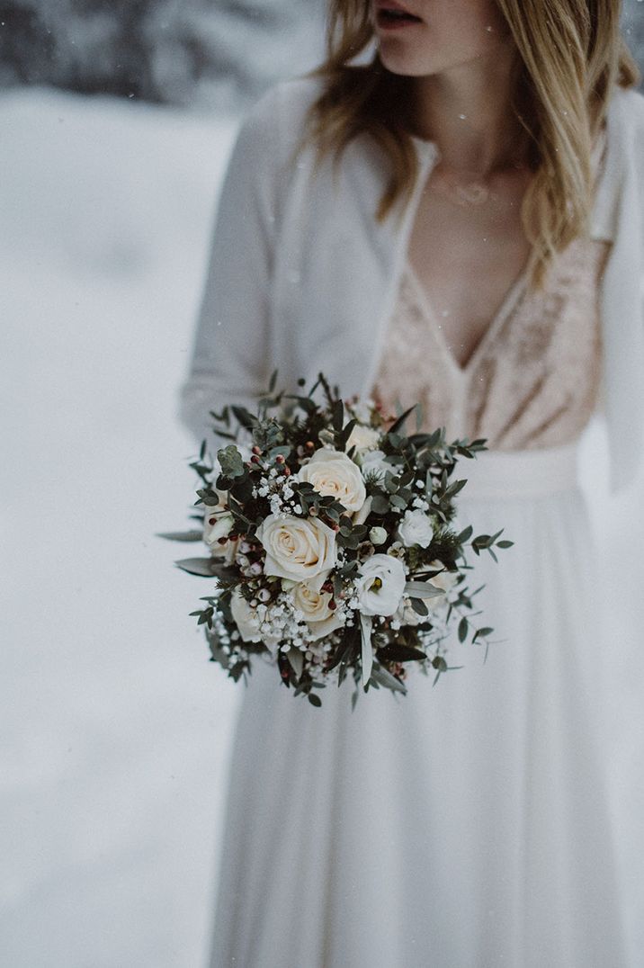 White winter wedding bouquet with white roses and gypsophila 