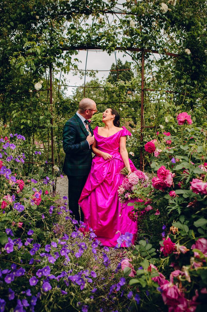 Bride in Vivienne Westwood bright hot pink wedding dress with groom top real weddings of 2023 