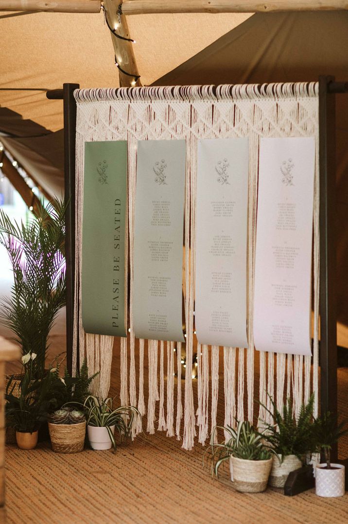 Green to white ombre wedding table plan signage with macrame tassel backdrop 