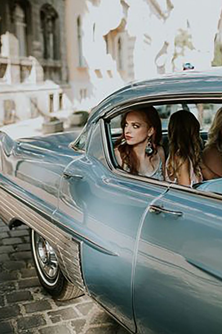 Women in a blue vintage style car as wedding transport in Budapest by Jágity Fanni Fotográfus Photography 