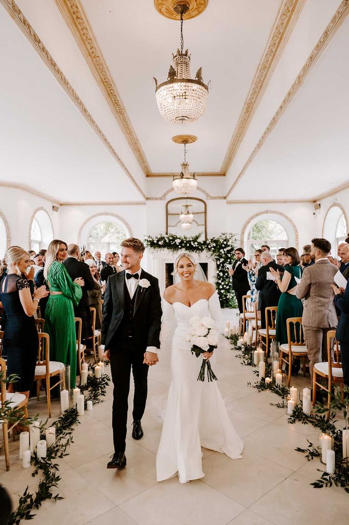 Elegant black-tie wedding at Northbrook Park with bride in a fitted off the shoulder wedding dress