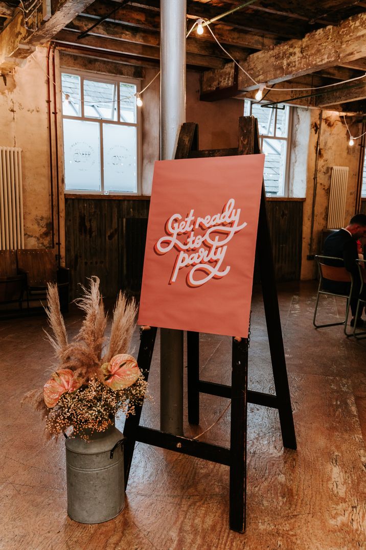 "Get ready to party" wedding sign on easel at Holmes Mill wedding