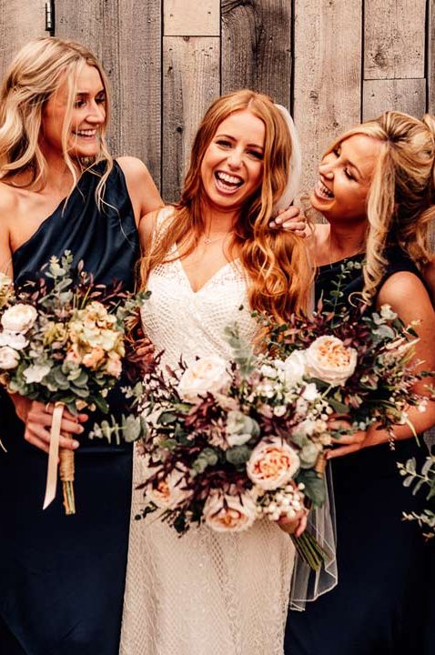 Bridal party holding reusable DIY artificial wedding bouquets