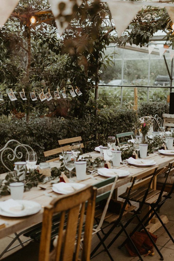 Rustic boho wedding tablescape with polaroid hanging decorations, fairy lights and bunting 