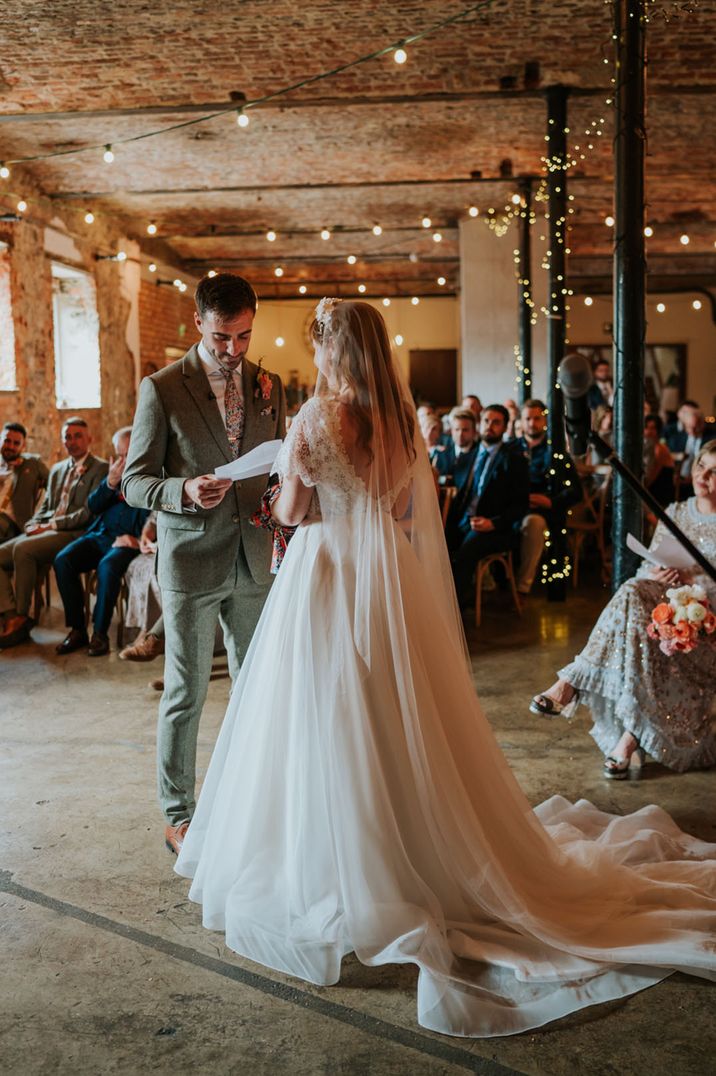 Bride and groom participate in their wedding ceremony at The Wool Tower industrial style wedding venue 