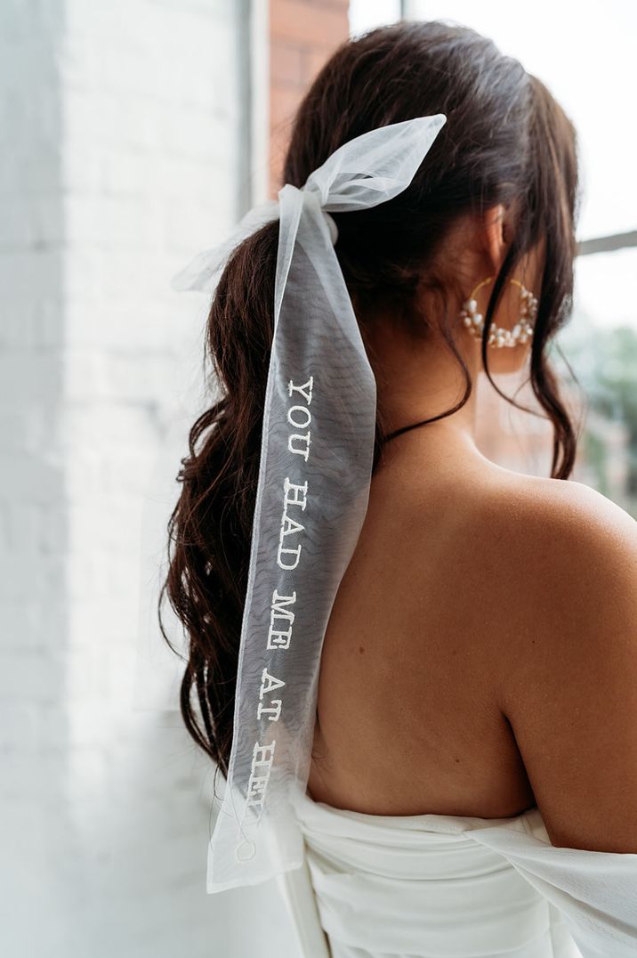 Bride wears personalised ribbon styled veil 