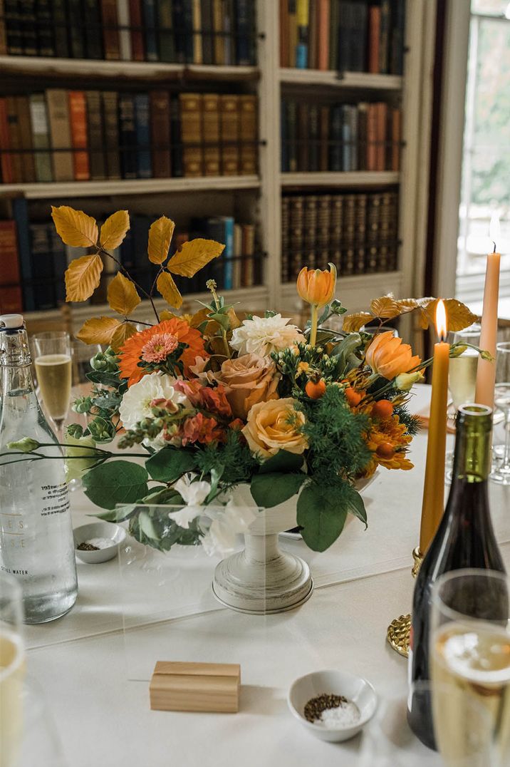 Bowl wedding table centrepieces with yellow tulips, roses, dahlias and autumn leaves 