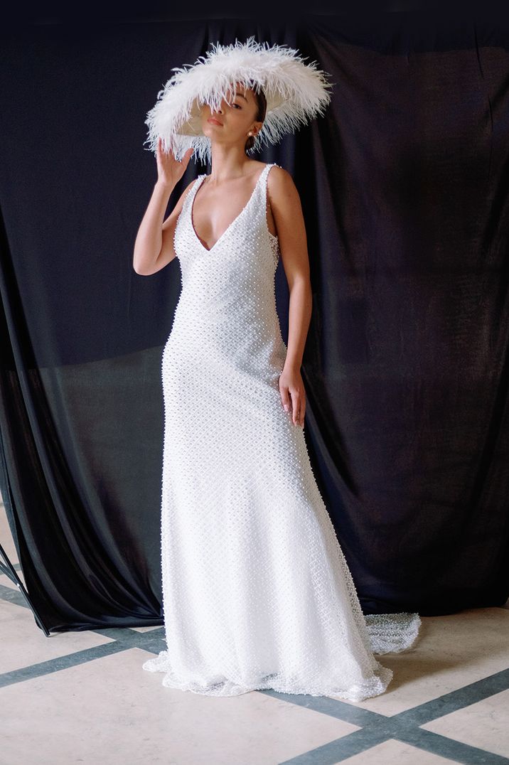 Bride wearing low cut v-neck pearl wedding dress 