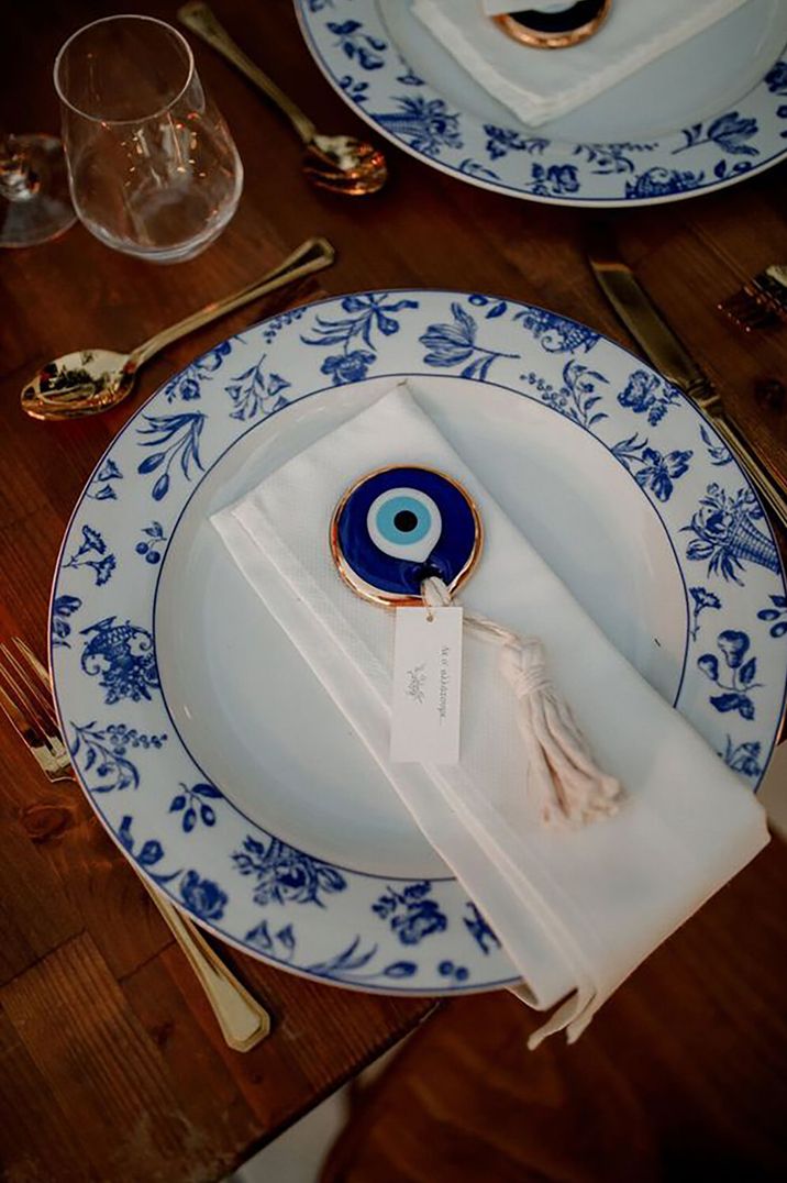 Blue and white china plates with evil eye charm for greek beach wedding by White on Black Studio Photography