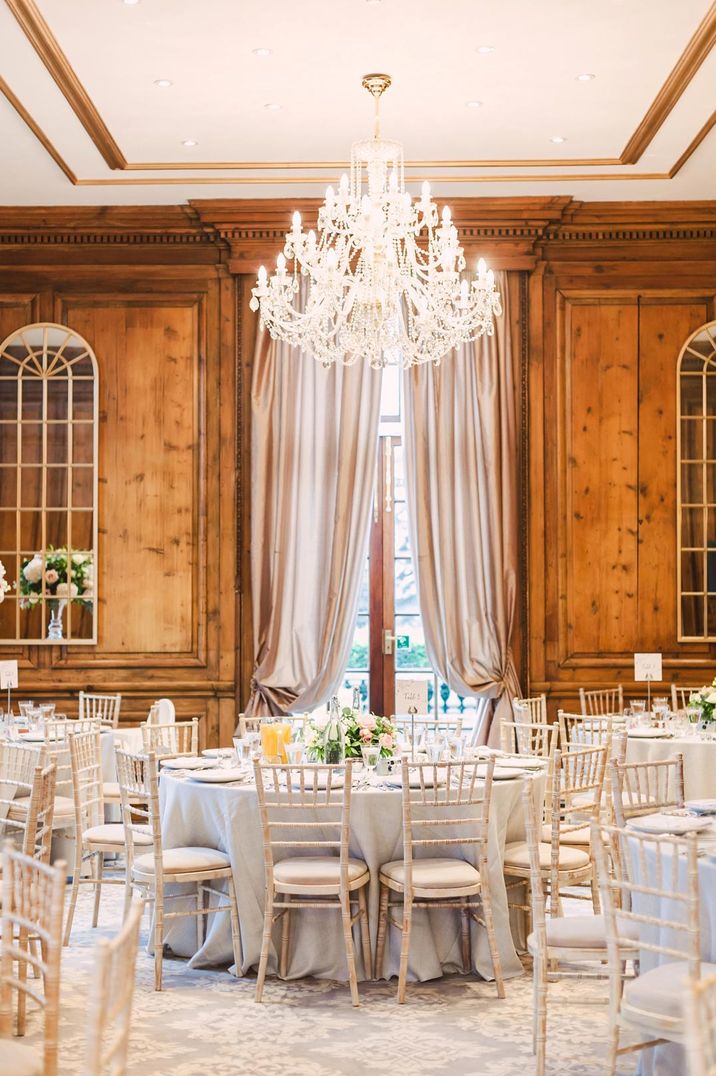 Large chandelier and cream tablescapes at Hedsor House