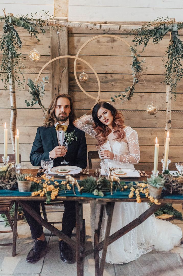 Modern wedding seating arrangements for boho wedding with sweetheart table and geometric decor 