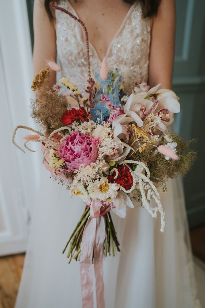 Colourful mixed flower wedding bouquet with peonies, carnations and orchids 