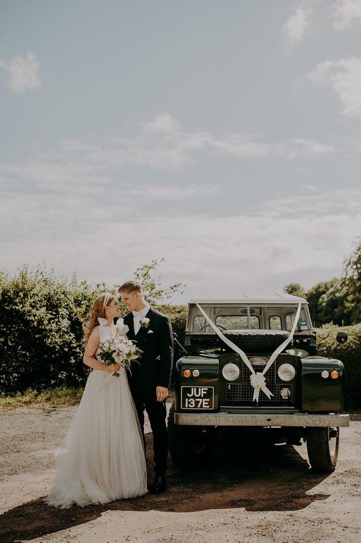 Black Land Rover wedding car with white top 