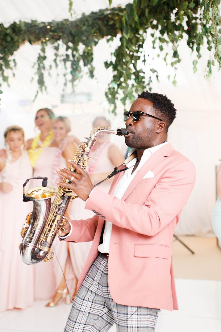 Saxophonist in a pink jacket playing at the Coddington Vineyard wedding venue 