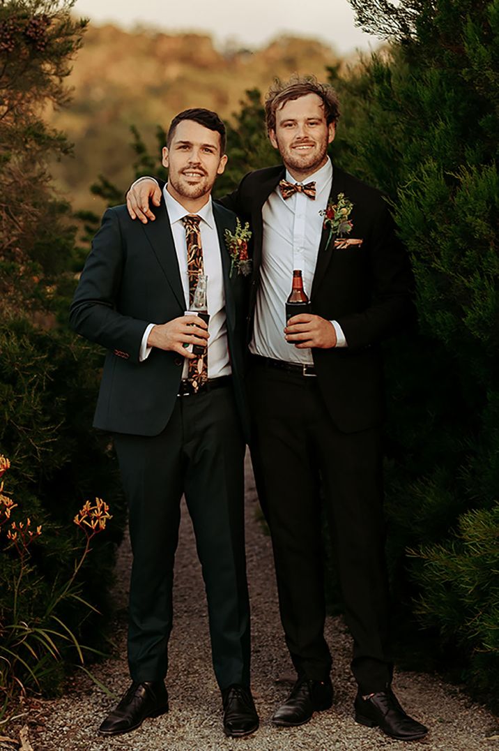 Groom and groomsmen in matching suits with brown, orange and yellow autumnal colours