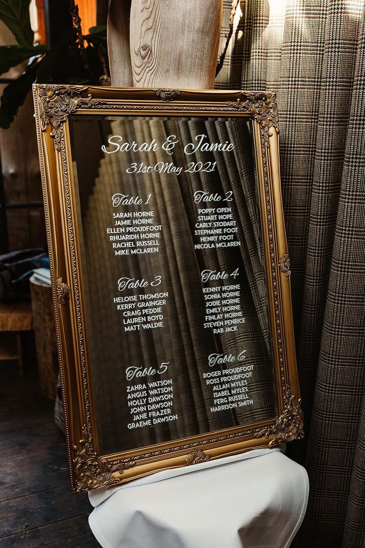 Vintage gold mirror with white calligraphy table plan 