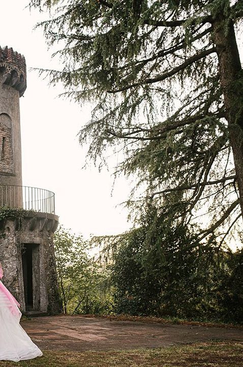  Le Due Torrette wedding venue in Italy - Bride and groom standing by venue tower