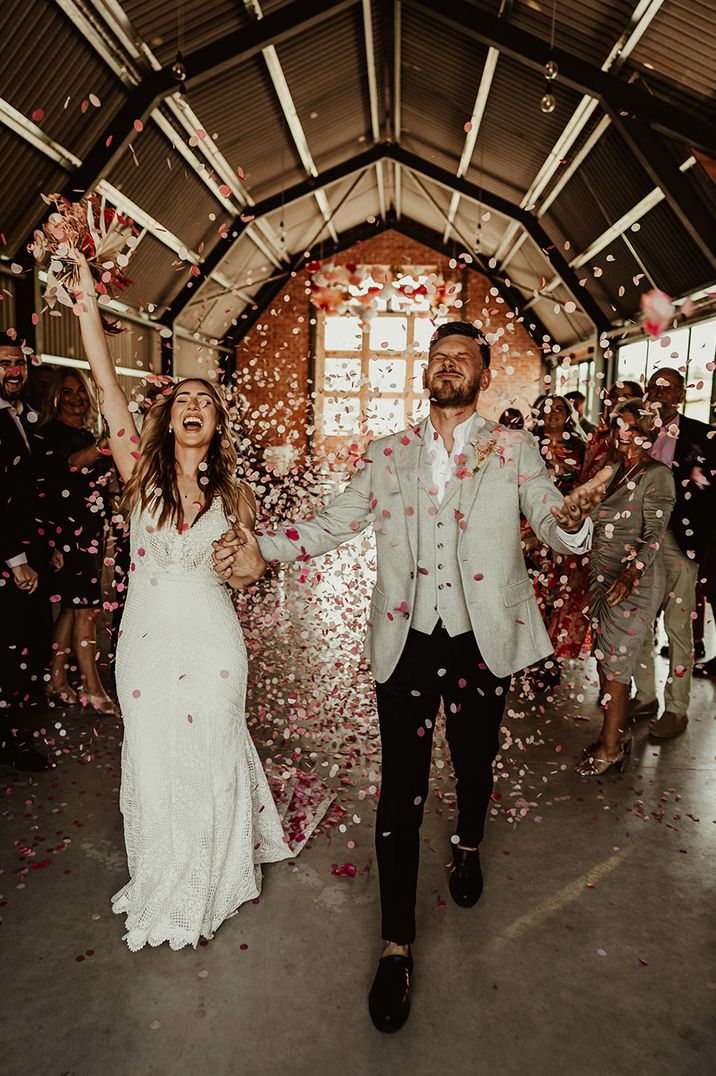 Pink and white confetti moment for the bride and groom 