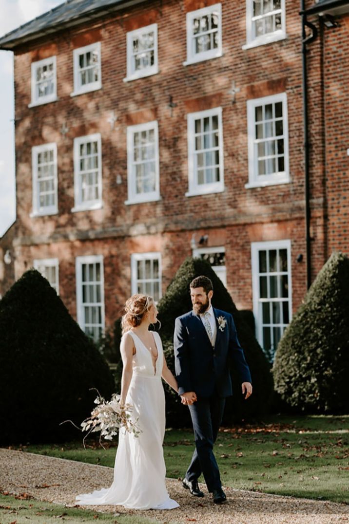 Sandon Manor country house wedding venue with the bride and groom walking around their venue 