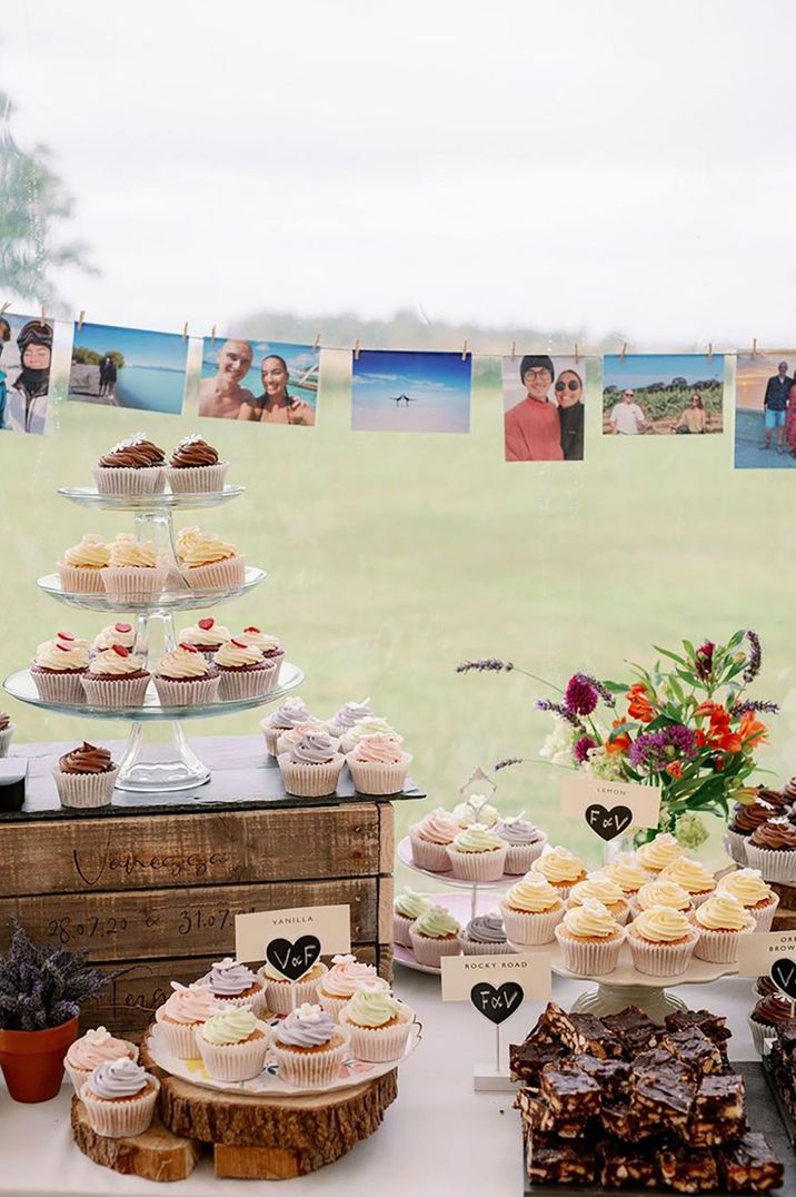 Marquee wedding with dessert table filled with cupcakes of all different flavours with rocky roads