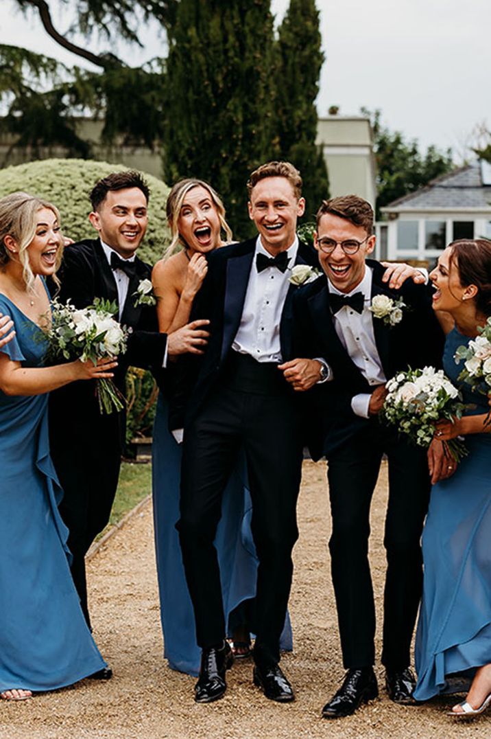 Wedding I Do Crew in dusky blue bridesmaid dresses and black tuxedos for classic country house black tie wedding 