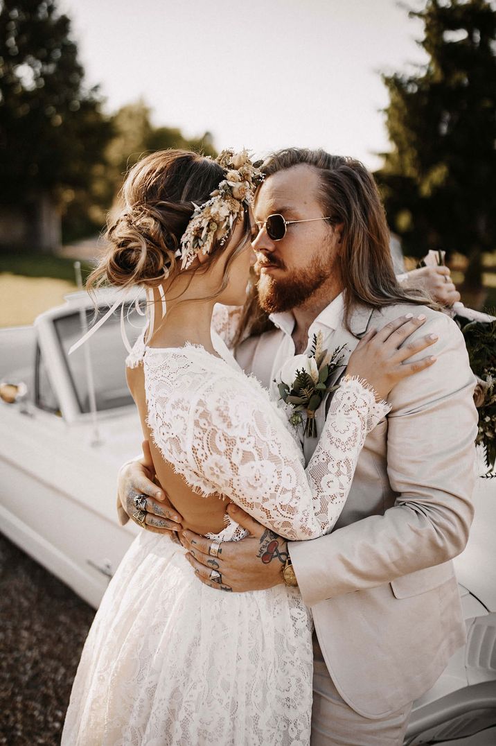 Bride in a lace long sleeve wedding dress with open back detail