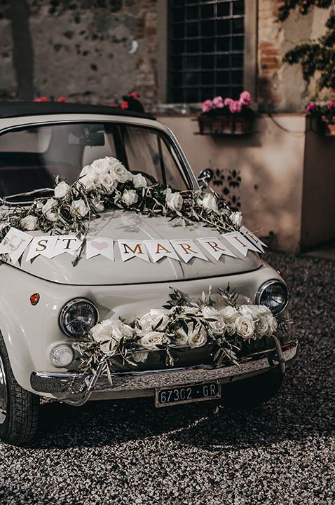 White Fiat 500 with "Just Married" and floral rose decorations