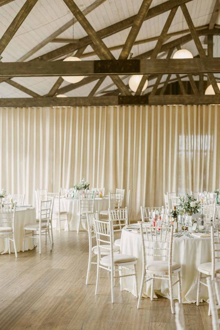 Wedding venues Scotland - Barra Castle wedding venue reception room with classic white tablescapes and off-white curtain