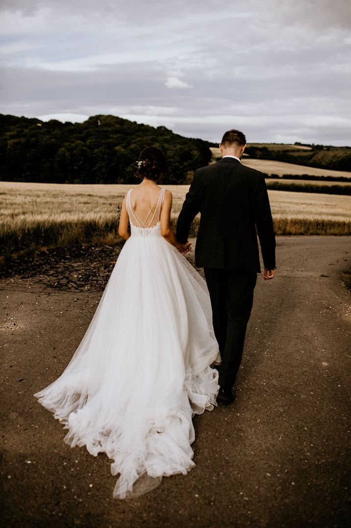 Cascading tulle princess wedding dress with strap back detailing by Chloe Mary Photo