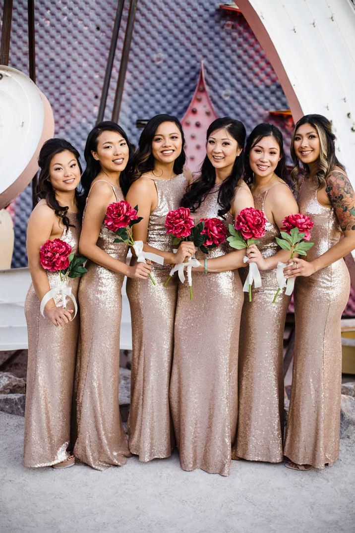 Bridesmaids wearing strappy gold sequin bridesmaid dresses - hen party ideas