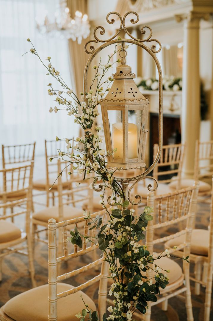 White lantern decorating the aisle at Bishop's Gate Hotel with white wax flower 