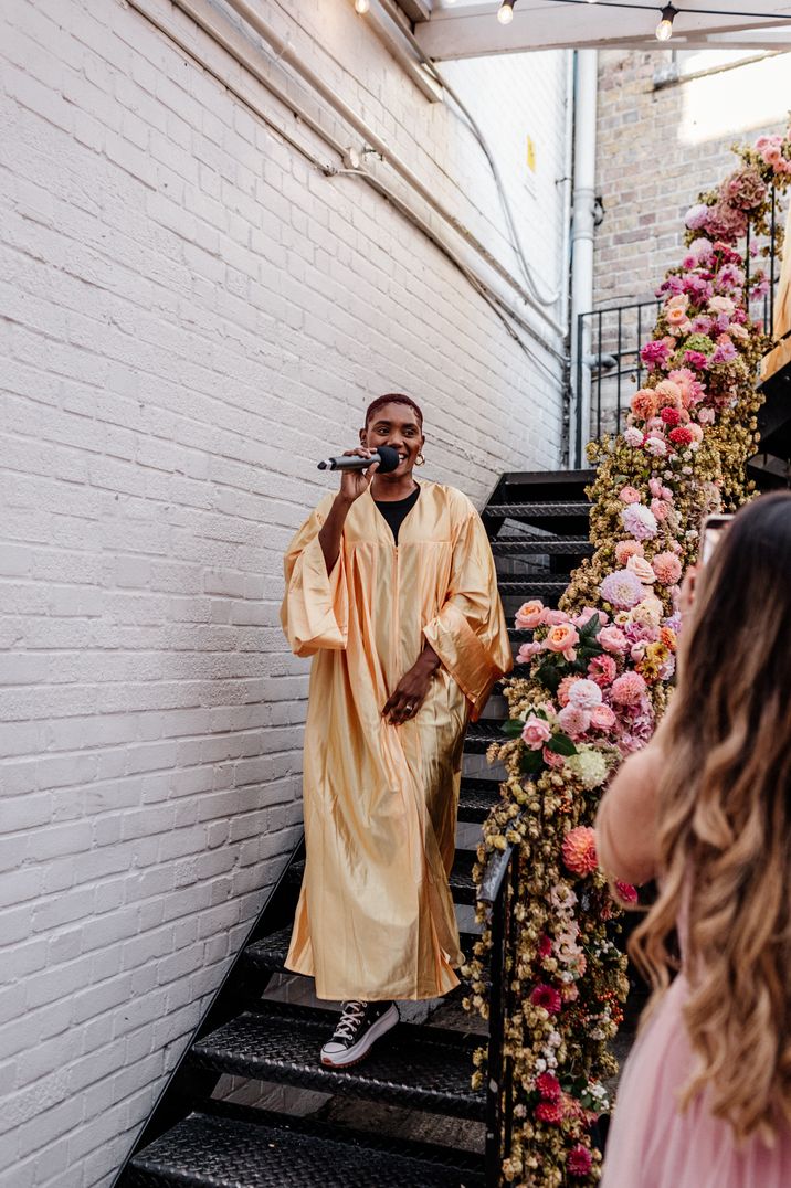 Person making wedding speech in long, golden robe 