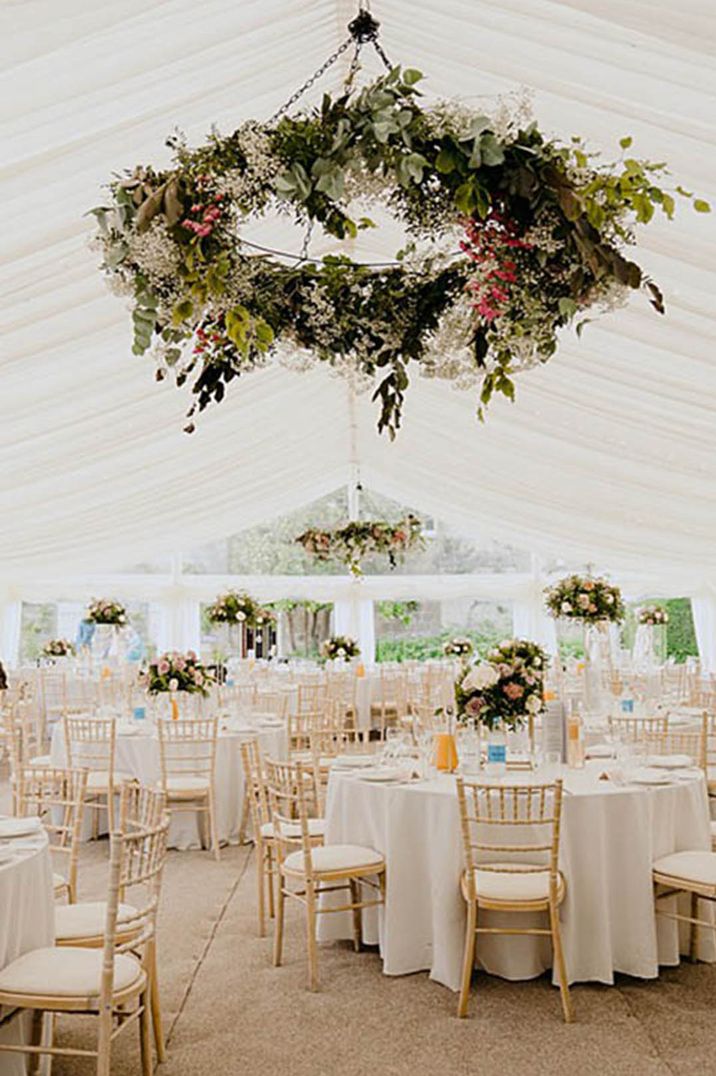 Marquee wedding with circular hanging floral installation for Asian multicultural wedding 